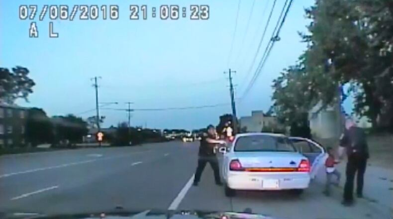 In this image made from July 6, 2016, video captured by a camera in the squad car of St. Anthony Police officer Jeronimo Yanez, the Minnesota police officer is shown after shooting into the vehicle at Philando Castile during a traffic stop in Falcon Heights, Minn., as the 4-year-old daughter of Castile's girlfriend, Diamond Reynolds, starts to get out of the car and is grabbed by an officer. The video was made public by the Minnesota Bureau of Criminal Apprehension and the Ramsey County Attorney's Office, Tuesday, June 20, 2017, just days after the officer was acquitted on all counts in the case. (St. Anthony Police Department via AP)