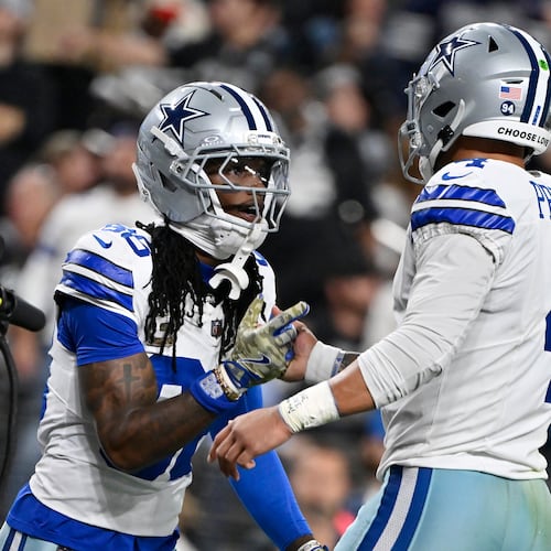 Dallas Cowboys wide receiver CeeDee Lamb, left, celebrates his touchdown against the Las Vegas Raiders with Cowboys quarterback Dak Prescott (4) during the first half of an NFL football game Monday, Nov. 17, 2025, in Las Vegas. (AP Photo/David Becker)