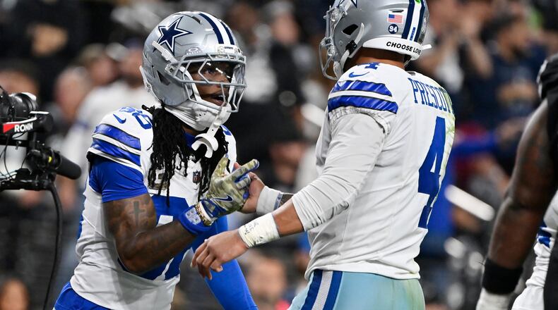 Dallas Cowboys wide receiver CeeDee Lamb, left, celebrates his touchdown against the Las Vegas Raiders with Cowboys quarterback Dak Prescott (4) during the first half of an NFL football game Monday, Nov. 17, 2025, in Las Vegas. (AP Photo/David Becker)