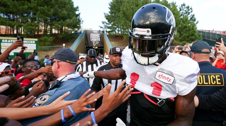 Fans reach out for Atlanta Falcons wide receiver Julio Jones (11) during the ninth annual “Kia Motors Friday Night Lights” at Grayson High School, Friday, August 5, 2016, in Loganville, Ga. BRANDEN CAMP/SPECIAL