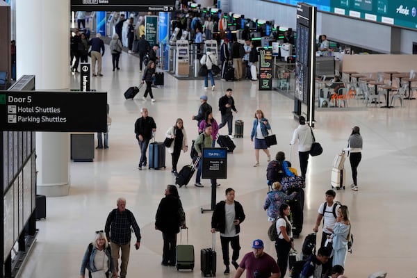 Travelers make their way through Terminal 1 at San Francisco International Airport ahead of the Memorial Day holiday weekend in San Francisco, Thursday, May 22, 2025. (AP Photo/Godofredo A. Vásquez)