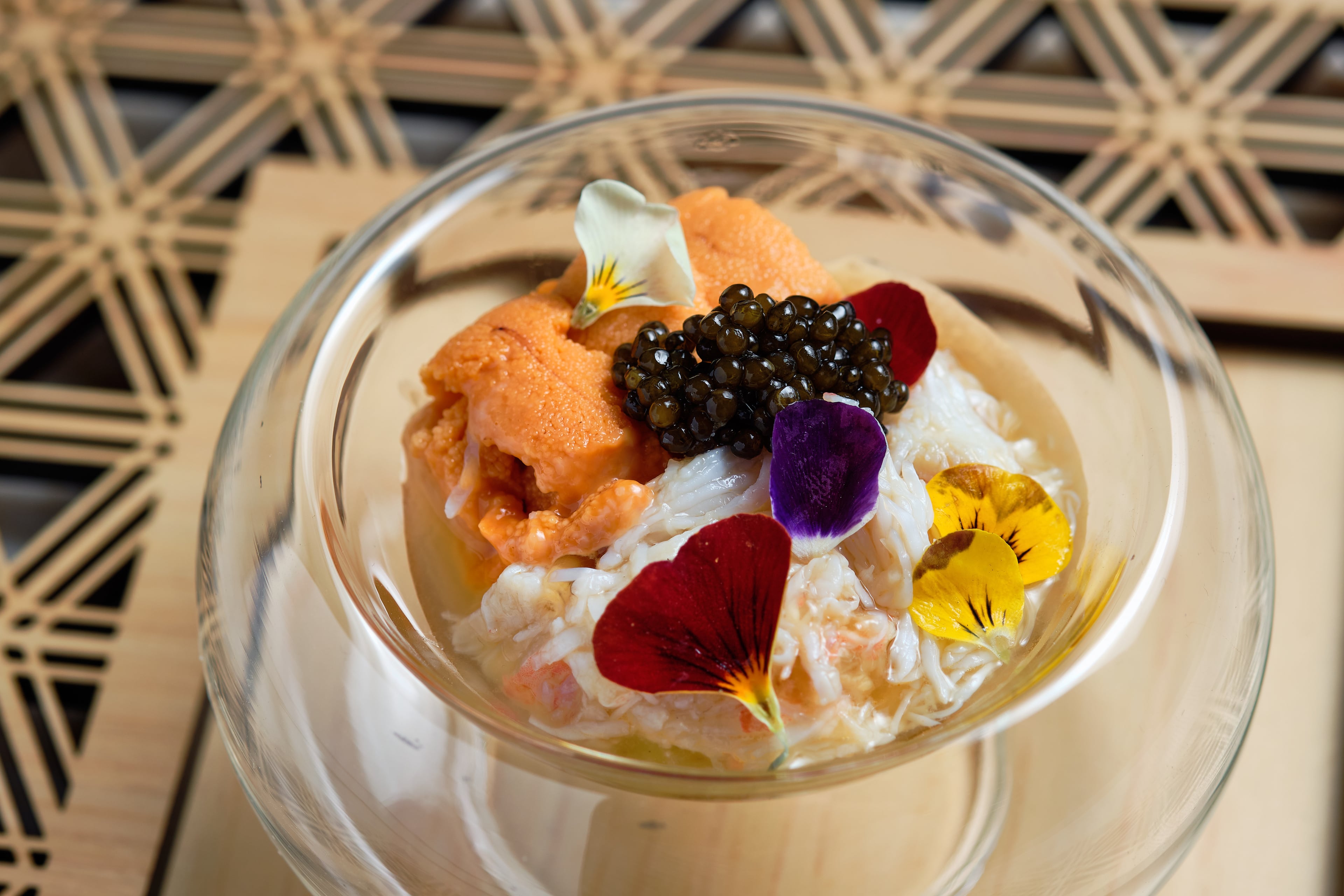 Kegani (horsehair crab) from Hokkaido with nama uni and keluga caviar layered over strips of cucumber and a rice vinegar gelee. Garnished with viola flowers. (Courtesy of Brandon Amato/Ryokou)