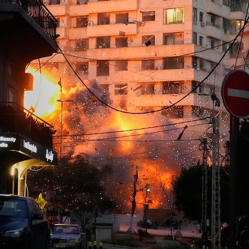 An explosion erupts from a building following an Israeli strike in central Beirut, Lebanon, Wednesday, March 18, 2026. (AP Photo/Hussein Malla)