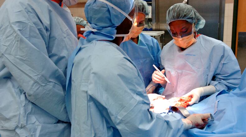 A surgery takes place at Grady Memorial Hospital in Atlanta. A large share of Grady’s patients are uninsured and can’t pay, so the federal government subsidizes the hospital for some of that. The subsidies are now being cut. PHOTO by ELISSA EUBANKS / AJC