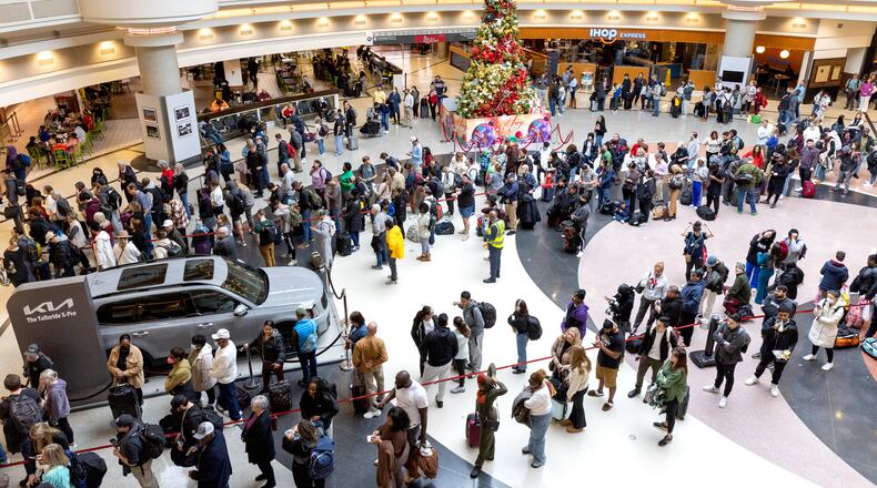 Travelers wait in long lines at the domestic terminal of Hartsfield-Jackson airport in Atlanta on Tuesday, December 26, 2023, the day after Christmas. (Arvin Temkar / arvin.temkar@ajc.com)
