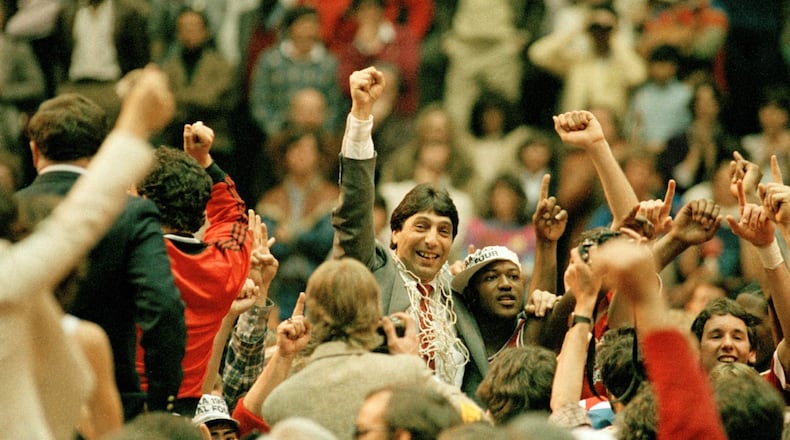N.C. State coach Jim Valvano with guard Dereck Whittenburg after the Wolfpack upset Houston 54-52 for the 1983 NCAA title.