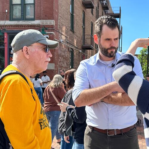 Iowa state Sen. Zach Wahls, a Democratic candidate for U.S. Senate, talks with voters in Des Moines, Iowa, Saturday, May 23, 2026. (AP Photo/Hannah Fingerhut)