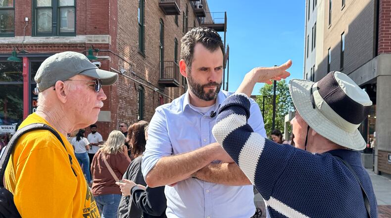 Iowa state Sen. Zach Wahls, a Democratic candidate for U.S. Senate, talks with voters in Des Moines, Iowa, Saturday, May 23, 2026. (AP Photo/Hannah Fingerhut)