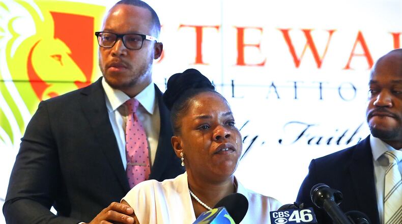 Rayshard Brooks’ widow, Tomika Miller, is moved to tears after learning new details of her husband’s death while addressing the media with family attorneys L. Chris Stewart (right) and Justin Miller (left) at Stewart Trial Attorneys on Wednesday, June 17, 2020, in Atlanta. Fulton County District Attorney Paul Howard had just announced that former Atlanta Police officer Garrett Rolfe, who shot Brooks twice during a suspected DUI arrest, would be charged with felony murder. Curtis Compton ccompton@ajc.com