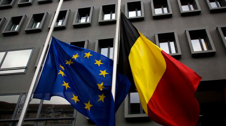 The European and the Belgian national flag set on half staff after terrorist attacks in Brussels in front of the Belgium Embassy in Berlin, Germany, Tuesday, March 22, 2016. (AP Photo/Markus Schreiber)