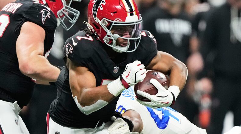Atlanta Falcons running back Bijan Robinson (7) carries against Los Angeles Rams linebacker Omar Speights (48) in the first half of an NFL football game, Monday, Dec. 29, 2025, in Atlanta. (AP Photo/Brynn Anderson)