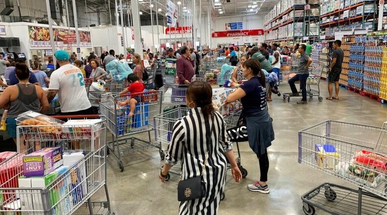 Shoppers stand in line waiting to check out at Costco ahead of Hurricane Dorian on Thursday, Aug. 29, 2019, in Davie, Fla. AP Photo/Brynn Anderson