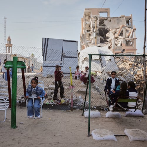 FILE - Displaced Palestinian children play on a swing at a tent camp as they mark the Muslim holiday of Eid al-Fitr in Gaza City, Friday, March 20, 2026. (AP Photo/Abdel Kareem Hana, file)