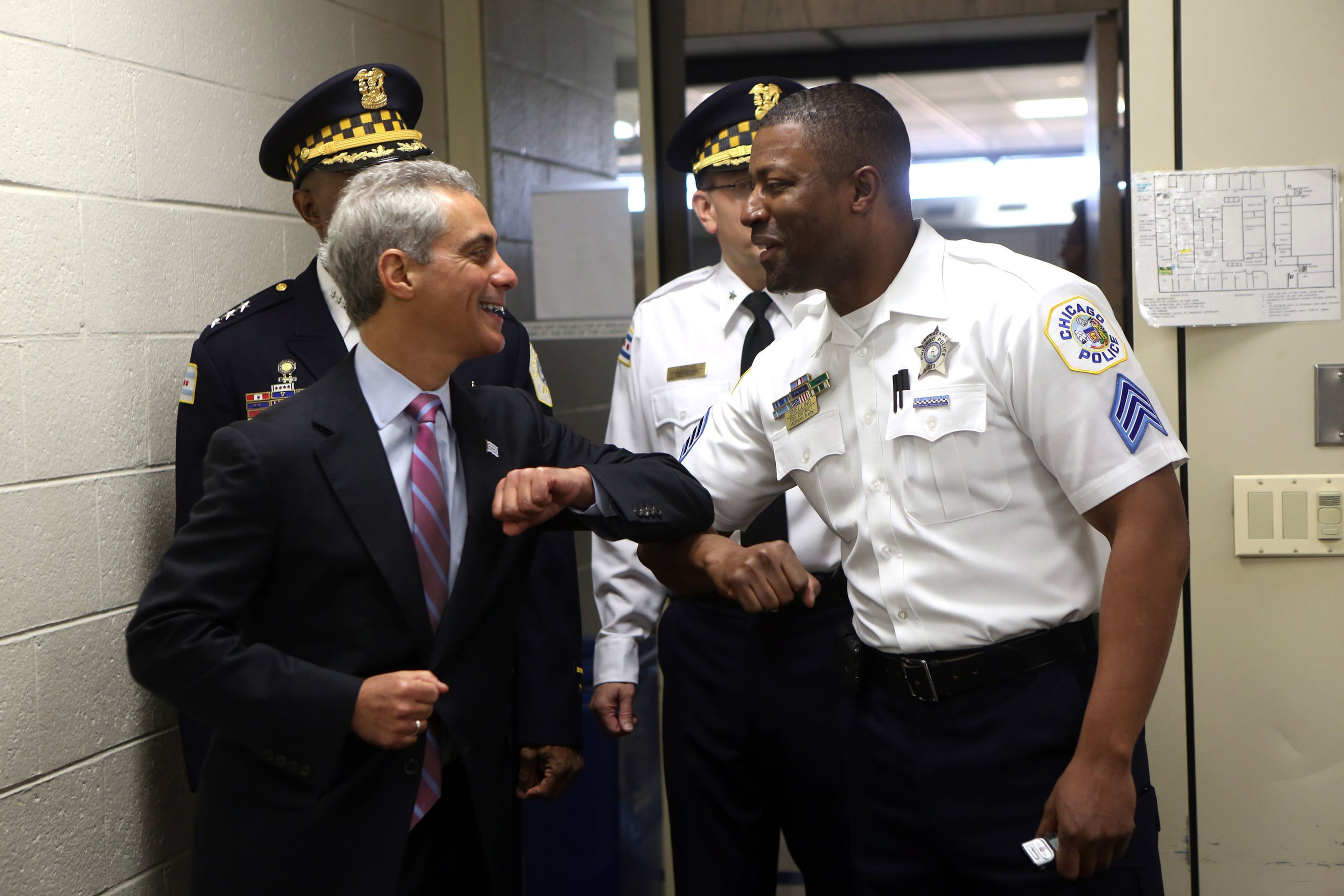 Former Chicago Mayor Rahm Emanuel (left), here greeting Police Sgt. Larry Snelling in 2012, said on a December podcast: “Nobody walks around going, ‘You know what? I feel 22% safer in 2024 than I did in 2023. Crime’s a feeling, a sense of a — a place of mind." (Nancy Stone/TNS 2012)