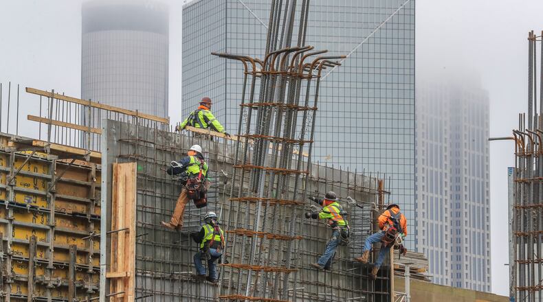 Overall, metro Atlanta added 72,000 jobs last year. The construction sector, which has about 146,000 workers, grew by 4,700. Here, workers on an 18-story, 304-unit apartment tower being built across from Mercedes-Benz Stadium near downtown. (John Spink / John.Spink@ajc.com)