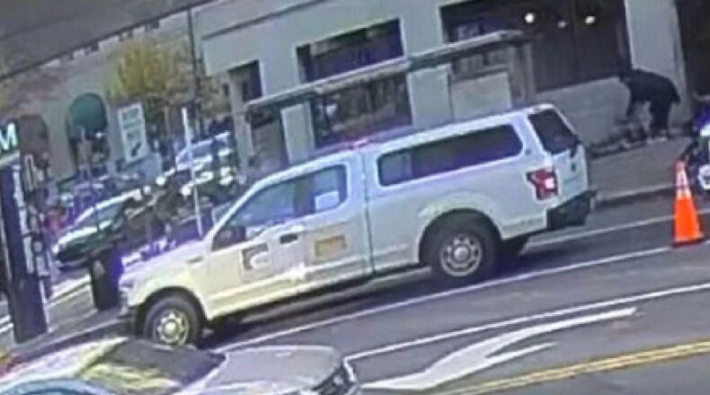 This image contained in a court filing by the Department of Justice on Tuesday, Dec. 2, 2025 shows the the defendant, Rahmanullah Lakanwal, top right, bending down next to Specialist Sarah Beckstrom and Staff Sgt. Andrew Wolfe after shooting them, according to police. (Department of Justice via AP)