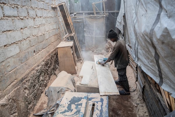 Isaac works in a carpentry shop that is powered in part by solar energy in Goma, Congo, May 23, 2025. (AP Photo/Moses Sawasawa)