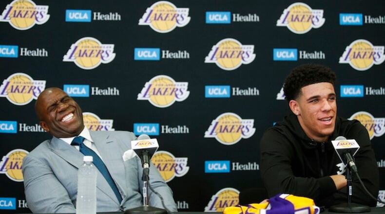 Magic Johnson, left, laughs as Los Angeles Lakers draft pick Lonzo Ball tells reporters he wasn't born when Johnson played for the Lakers during a news conference, Friday, June 23, 2017, in El Segundo, Calif. (AP Photo/Jae C. Hong)