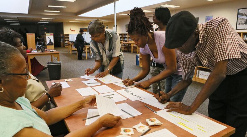 Voters signed in to cast ballots at Mary McLeod Bethune Middle School in July. Bob Andres/BANDRES@AJC.COM