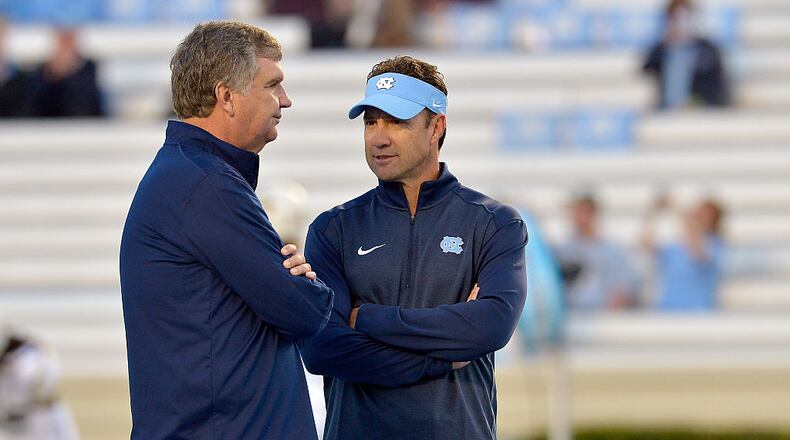 Head coach Paul Johnson of the Georgia Tech Yellow Jackets, left, talks with head coach Larry Fedora of the North Carolina Tar Heels before their game at Kenan Stadium on October 18, 2014 in Chapel Hill, North Carolina. (Photo by Grant Halverson/Getty Images)