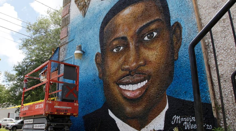 In this May 17, 2020, photo, a recently painted mural of Ahmaud Arbery is on display in Brunswick, Ga., where the 25-year-old man was shot and killed in February. It was painted by Miami artist Marvin Weeks.