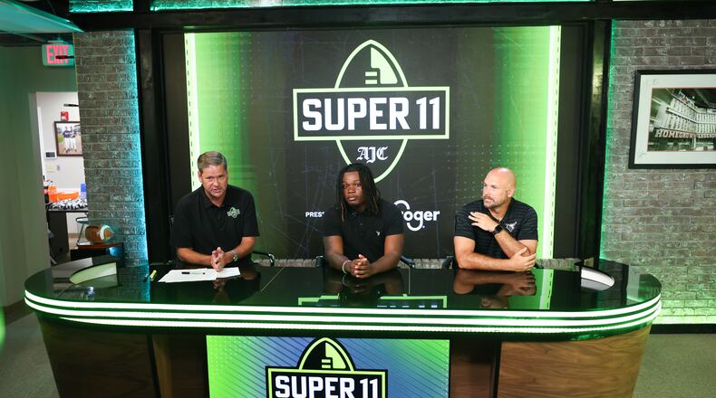 DawgNation’s Brandon Adams interviews Kell’s Quinterrius “Moonie” Gipson and coach Bobby May during the taping of the Super 11 reveal show at Score ATL in Roswell on Aug. 3, 2026. (Arvin Temkar/AJC)