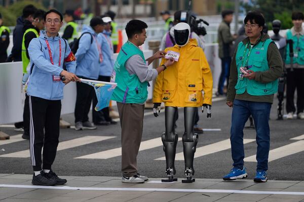 A robot takes part in what is billed as the world's first robot half marathon during the Humanoid Robot Half-Marathon held in Beijing on Saturday, April 19, 2025. (AP Photo/Ng Han Guan)
