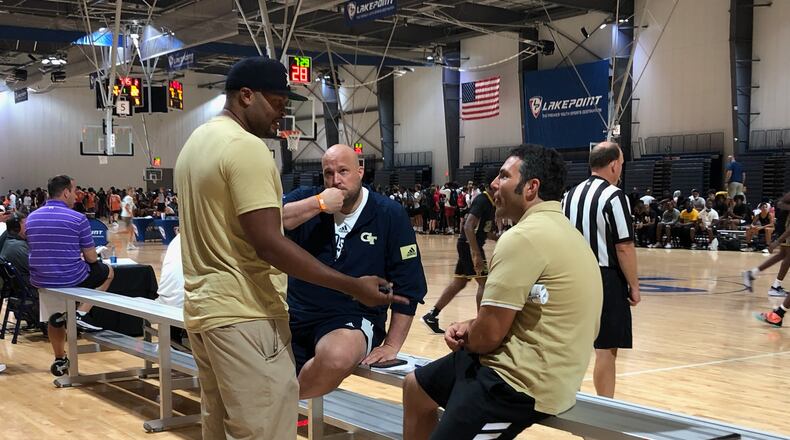 Georgia Tech coach Josh Pastner (seated right) converses with assistant coaches Anthony Wilkins (standing) and Julian Swartz (seated left) at the Georgia Basketball Coaches Association team camp at the LakePoint Sports complex in Emerson on June 18, 2021. (AJC photo by Ken Sugiura)
