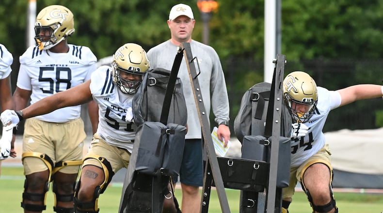 Georgia Tech offensive linemen Paul Tchio (57) and Ryan Purves (64) work on their drills during the first football practice of the season at Rose Bowl Field on Georgia Tech Campus in Atlanta on Friday, August 5, 2022. (Hyosub Shin / Hyosub.Shin@ajc.com)
