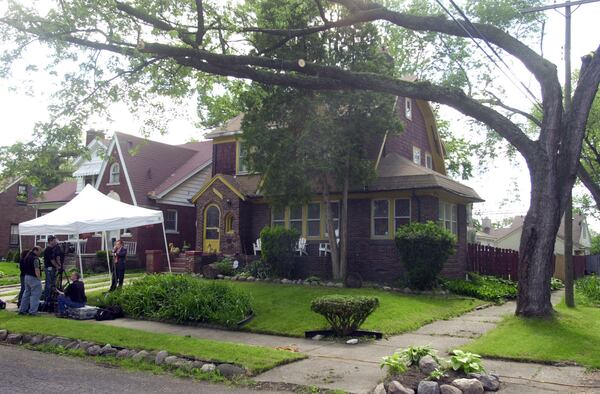 In this Friday, May 28, 2004 file photo, television crews set up camp outside a house in northwest Detroit, where investigators looking into the 1975 disappearance of Teamsters boss Jimmy Hoffa ripped up floor boards. 