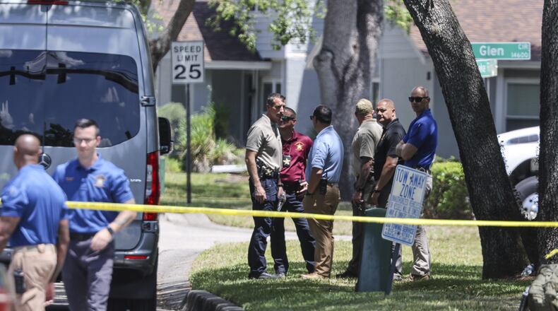 Detectives with the Hillsborough County Sheriff's Office join an investigation inside the Lake Forest subdivision of Tampa, Fla., on Friday, April 24, 2026, where authorities said a man was taken into custody after barricading himself inside a home, in connection to the search for two missing University of South Florida graduate students. (Douglas R. Clifford/Tampa Bay Times via AP)
