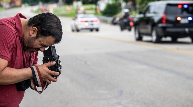 University of Texas graduate student, Luke Perez, uses a twin lens film camera to take pictures during the Duetschen Pfest Parade held in Pflugerville, Texas, on Saturday, May 21, 2016.