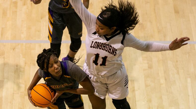 Kell High School freshman Jada Green (right) blocks Jones County freshman Kimmya Epps (1). (Photo/Rebecca Wright for the AJC)