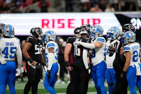 Detroit Lions and Atlanta Falcons players hug after Lions safety Morice Norris was injured on Friday, Aug. 8, 2025, in Atlanta. (Brynn Anderson/AP)