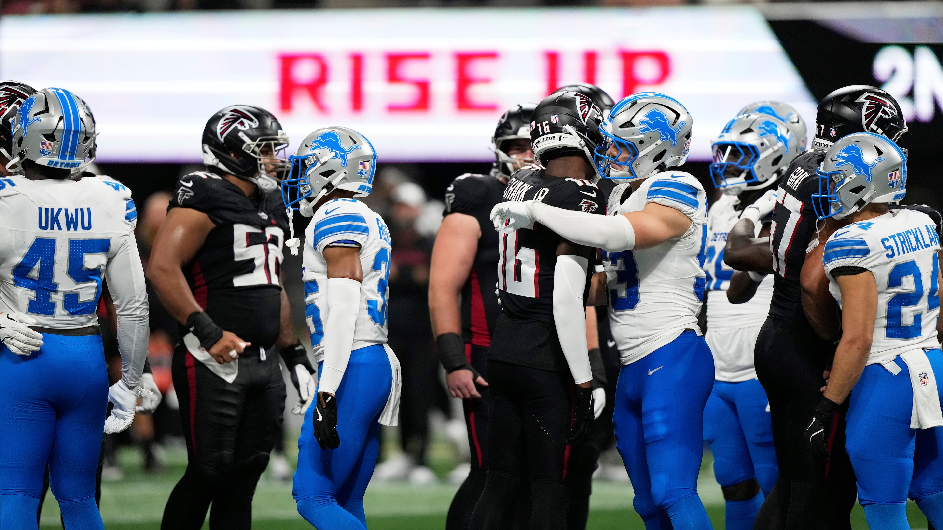 Detroit Lions and Atlanta Falcons players hug after Detroit Lions safety Morice Norris was injured during the second half of an NFL preseason football game Friday, Aug. 8, 2025, in Atlanta. (AP Photo/Brynn Anderson)