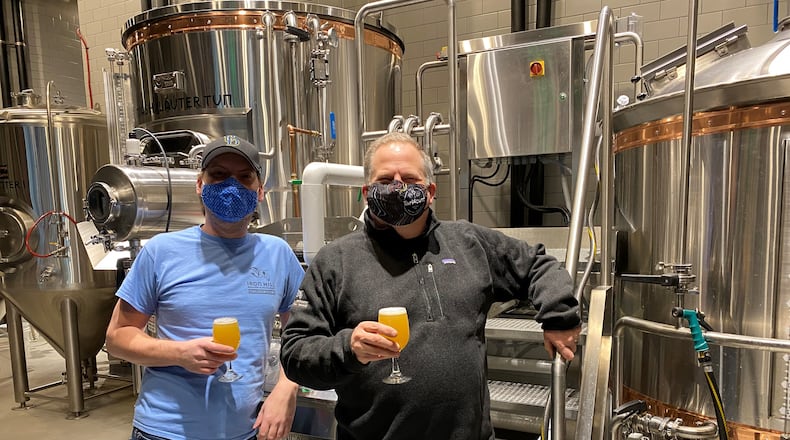 Director of Brewing Operations Mark Edelson (right) and head brewer Alex Vanderlek are at Iron Hill Brewery & Restaurant in Buckhead. Bob Townsend for The AJC