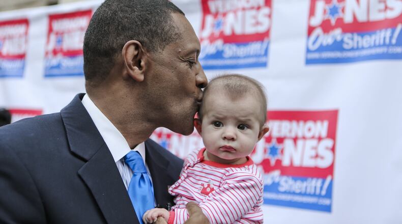 Vernon Jones kisses 5-month old, Harper Gonzales, daughter of Mario and Jacqueline Gonzales. Former DeKalb CEO Vernon Jones made an expected announcement Thursday, Feb. 20, 2014 on the steps of the old DeKalb County Courthouse in Decatur formally unveiling his campaign for DeKalb County sheriff. JOHN SPINK/JSPINK@AJC.COM
