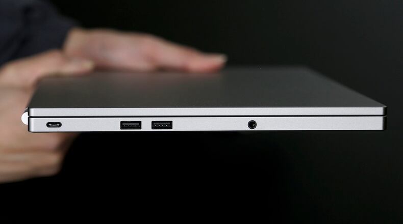 This Tuesday, March 10, 2015 photo shows, from left, the USB Type-C port, two standard USB ports, and headphone jack on a Google Chromebook Pixel laptop, in San Jose, Calif. (AP Photo/Jeff Chiu)