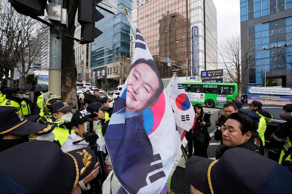 A support of South Korea's ousted President Yoon Suk Yeol confronts police officers to call for the cancellation of his removal in front of the Seoul Central District Court in Seoul, South Korea, Monday, April 14, 2025. (AP Photo/Ahn Young-joon)
