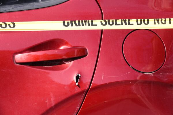 A bullet hole can be seen in the vehicle after the shooting.