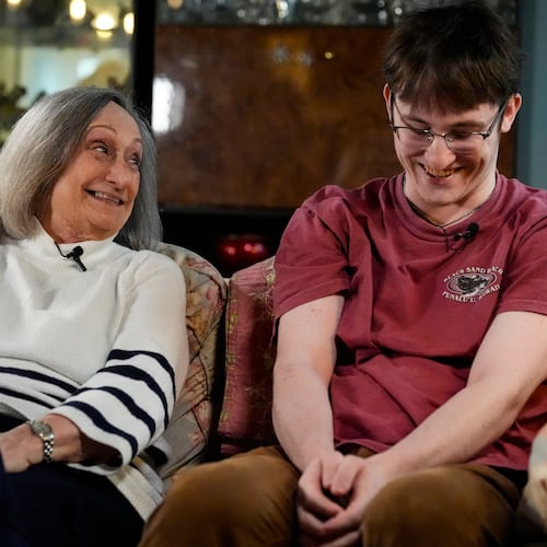 Donna West sits with her grandson Paul Quirk as they speak to a reporter, Tuesday, Dec. 2, 2025, in Marietta, Ga. (AP Photo/Mike Stewart)