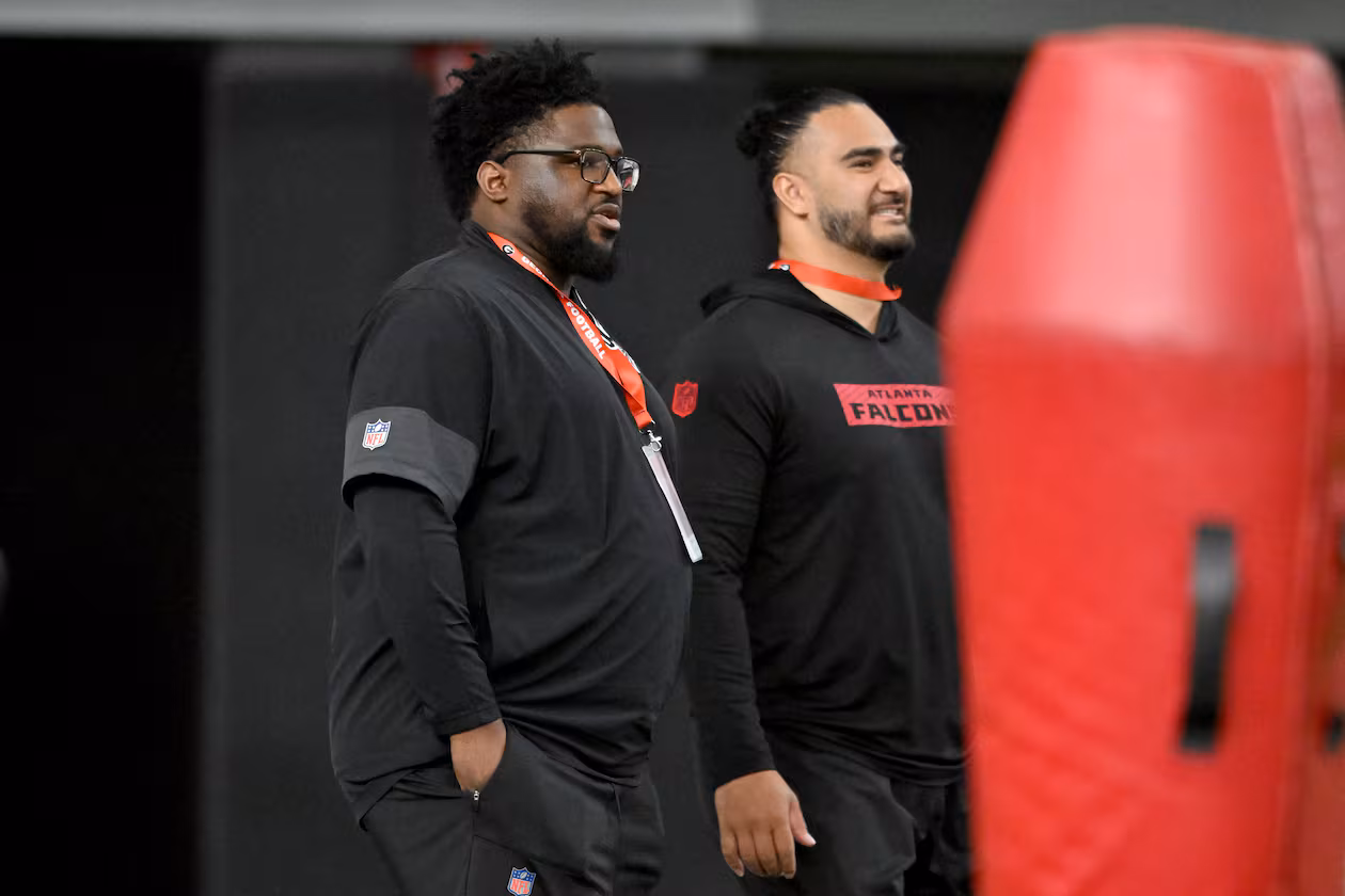 Atlanta Falcons defensive line coach Nate Ollie (left) and outside linebackers coach John Timu attend Georgia's NFL Pro Day at Payne Indoor Athletic Facility on March 18, 2026. (Hyosub Shin/AJC)