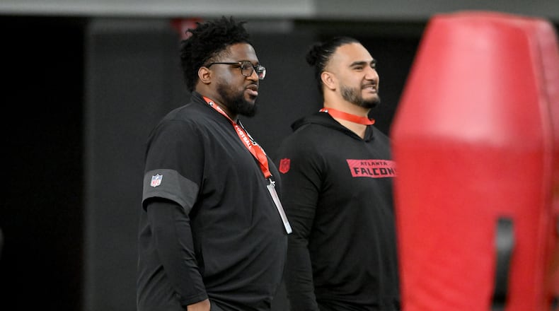 Atlanta Falcons defensive line coach Nate Ollie (left) and outside linebackers coach John Timu attend Georgia's NFL Pro Day at Payne Indoor Athletic Facility on March 18, 2026. (Hyosub Shin/AJC)