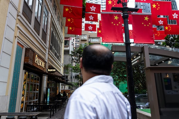 Chinese and Hong Kong SAR flags are hung outside restaurants in Hong Kong, Thursday, June 26, 2025. (AP Photo/Chan Long Hei)