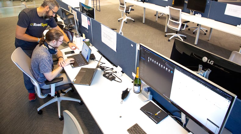 RoadSync employees Ivan Zhelezarov (L) and Alex Petralia work in the company's new office space in Atlanta. RoadSync and other companies are beginning to commit to having employees return to work by signing new office leases.  STEVE SCHAEFER FOR THE ATLANTA JOURNAL-CONSTITUTION
