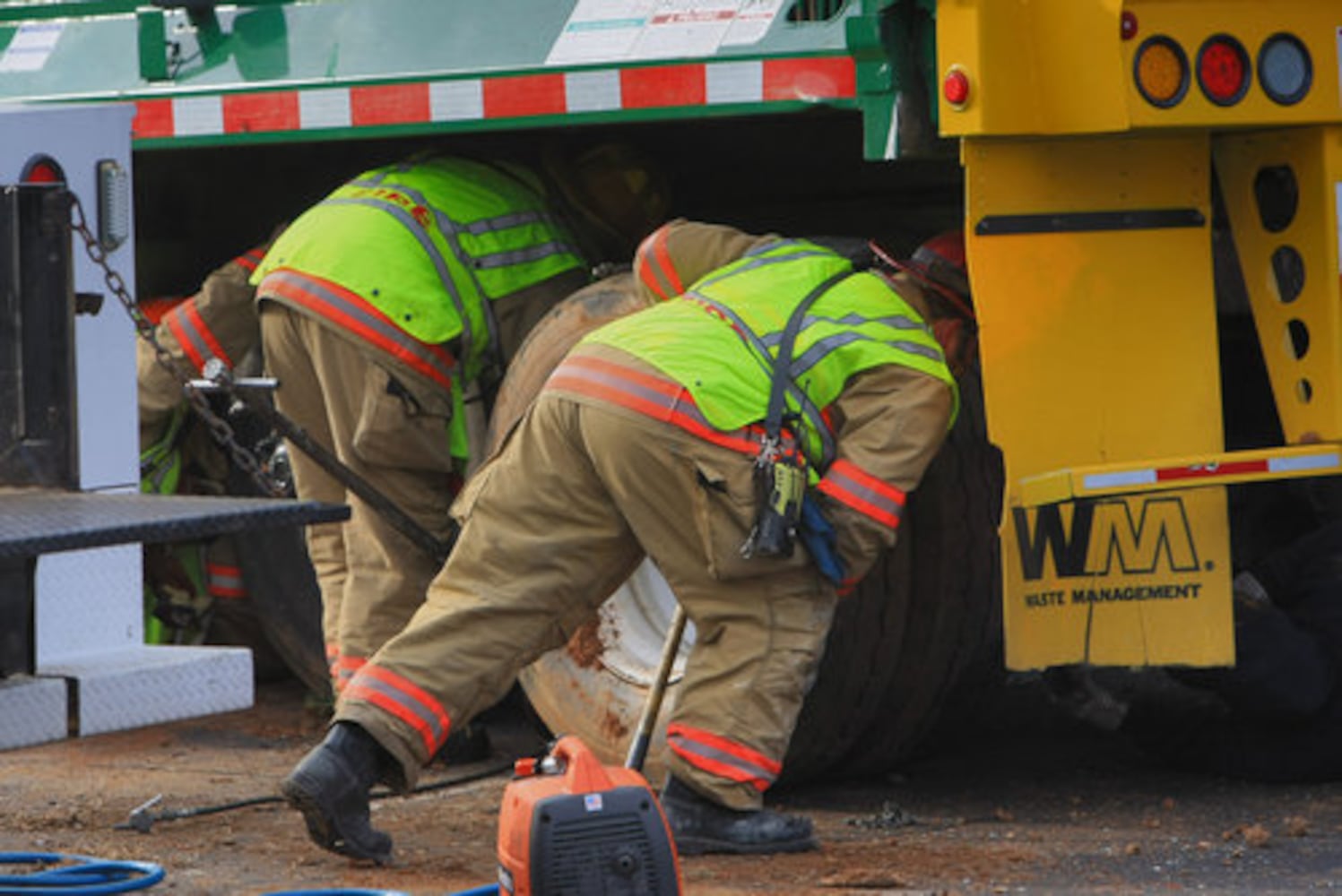 Garbage truck flips down hill, crushes cars