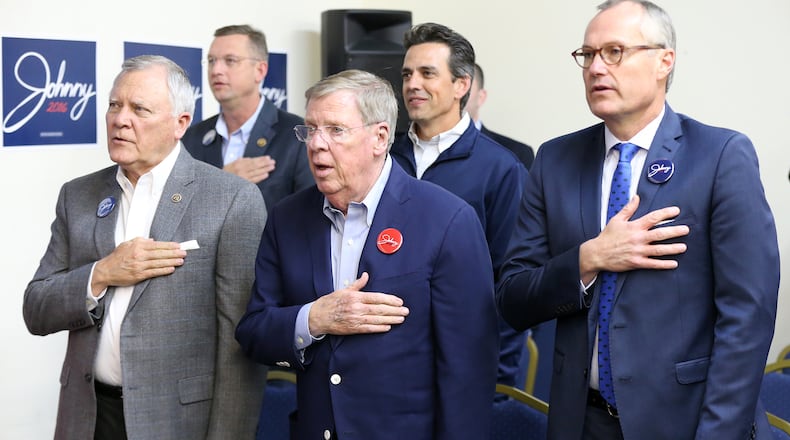 U.S. Sen. Johnny Isakson, center, U.S. Rep. Doug Collins (back, left) and U.S. Rep. Tom Graves (back, center) at a rally in Marietta in November. Curtis Compton,ccompton@ajc.com
