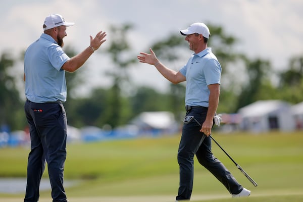 Masters champion Rory McIlroy, right, and partner Shane Lowry celebrate after McIlroy knocked in an eagle putt on the 18th hole during the Zurich Classic at TPC Louisiana in Avondale, Saturday, April 26, 2025. (Scott Threlkeld/The New Orleans Advocate via AP)