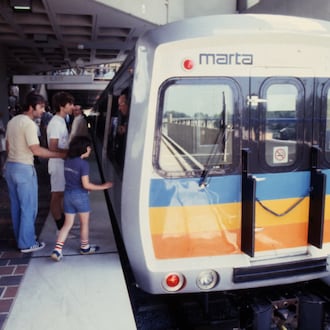 Passengers board the first MARTA train ride during the opening ceremonies of the East Lake Station in June 1979.