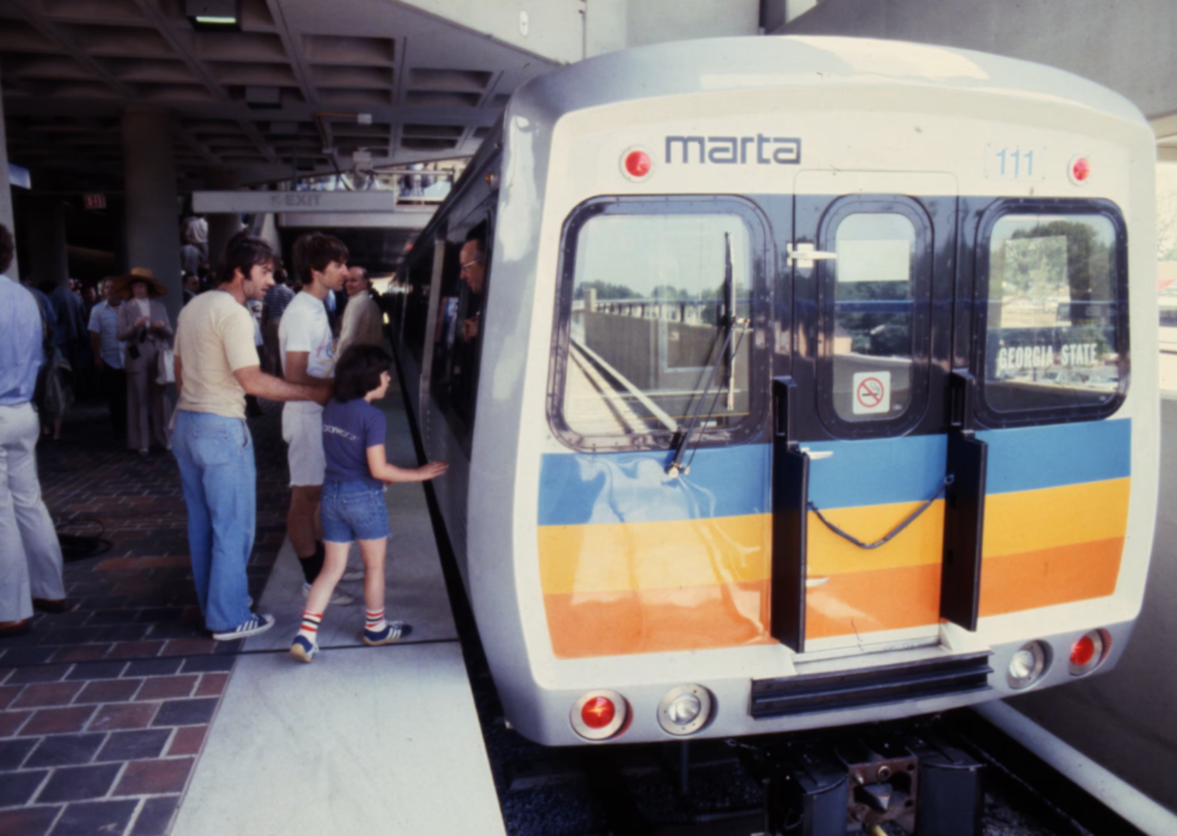 Passengers board the first MARTA train ride during the opening ceremonies of the East Lake Station in June 1979.